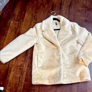Divided faux cream colored coat.